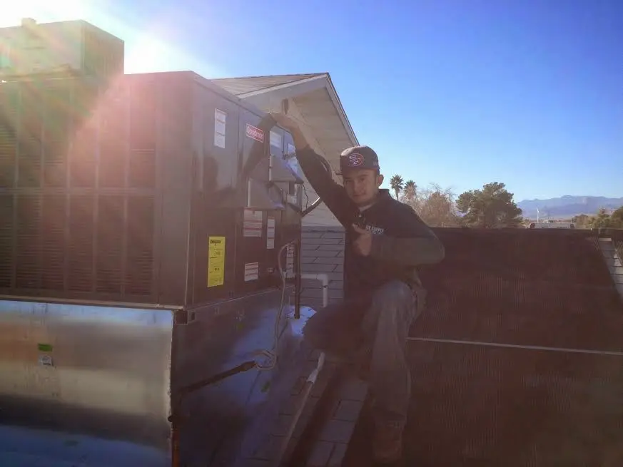 HVAC technician performing AC Tune-Up on a rooftop unit in Waynesboro